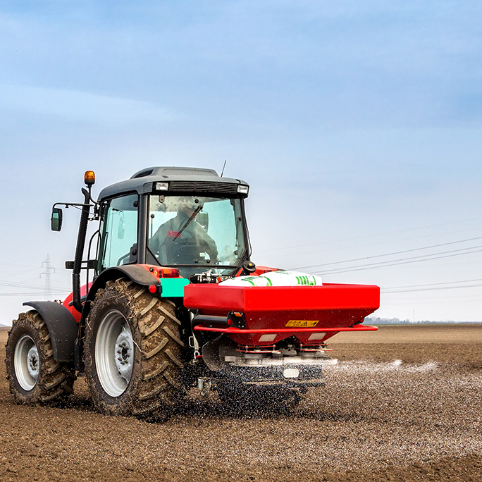 tracteur en train de mettre de l&#39;engrais dans un champ